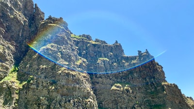 During the day under the blue sky blue cable car across the Rocky Mountains
